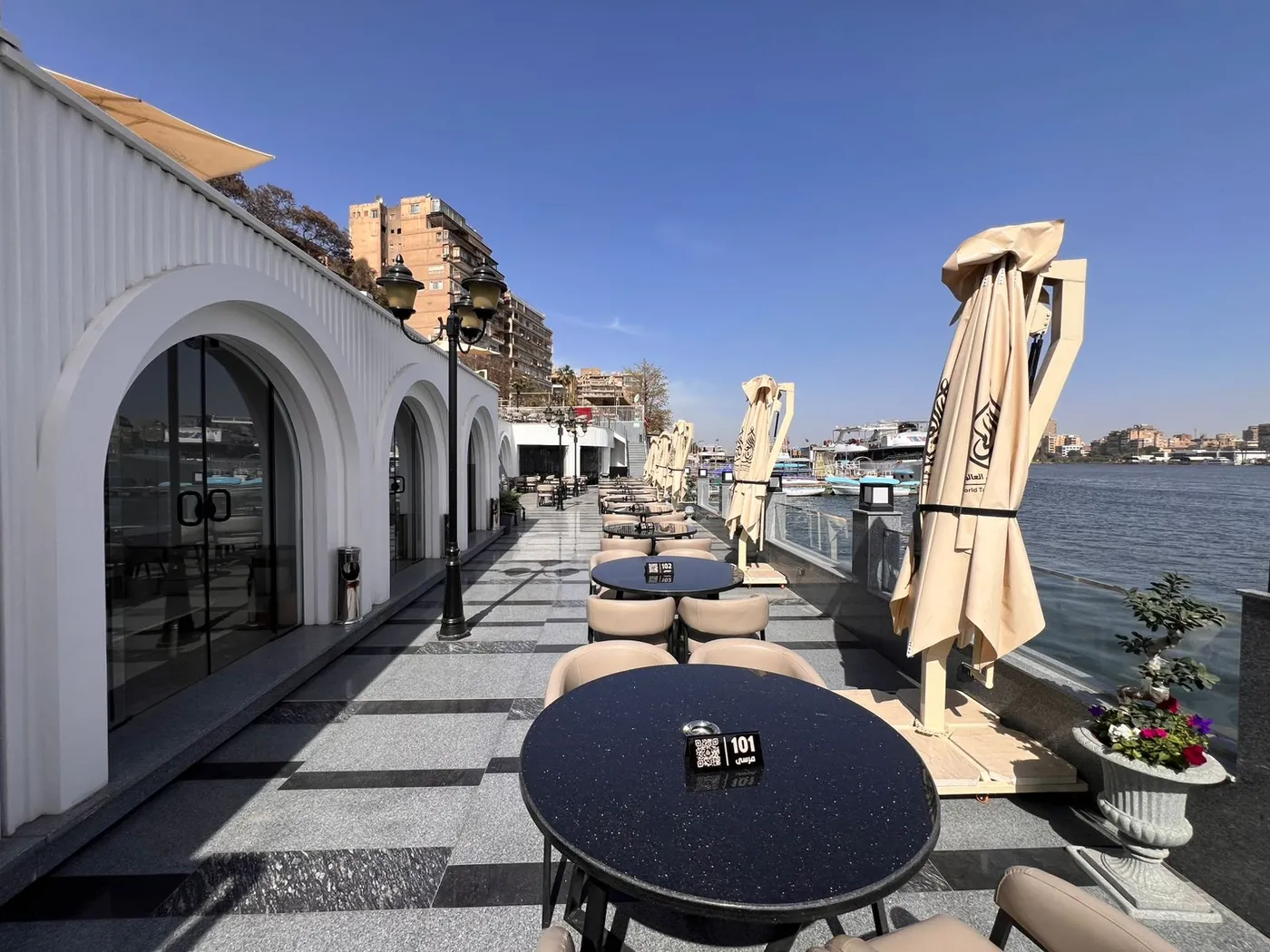 World Taste Restaurant — riverside terrace behind a fluted arcade