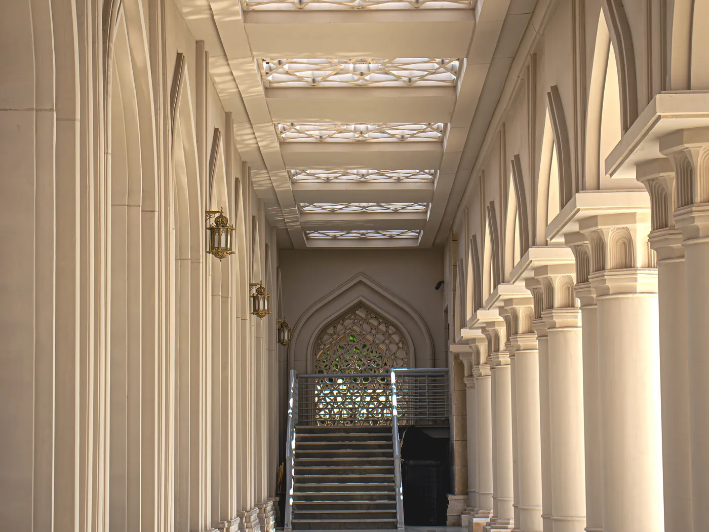 Al Aly Al Azaeem Mosque — interior colonnade lined with moulded wall panels and screens