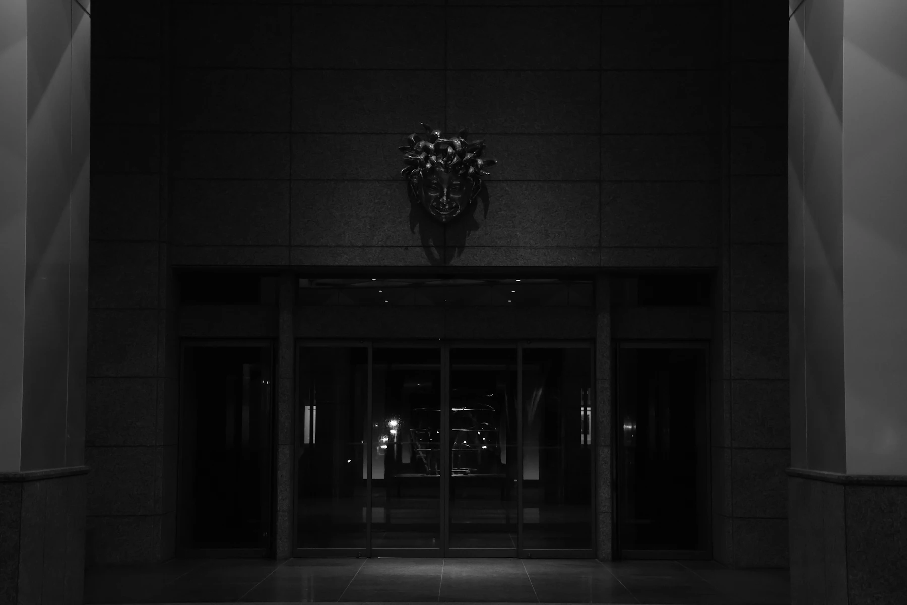 Dark stone entrance hall with a symmetrical composition