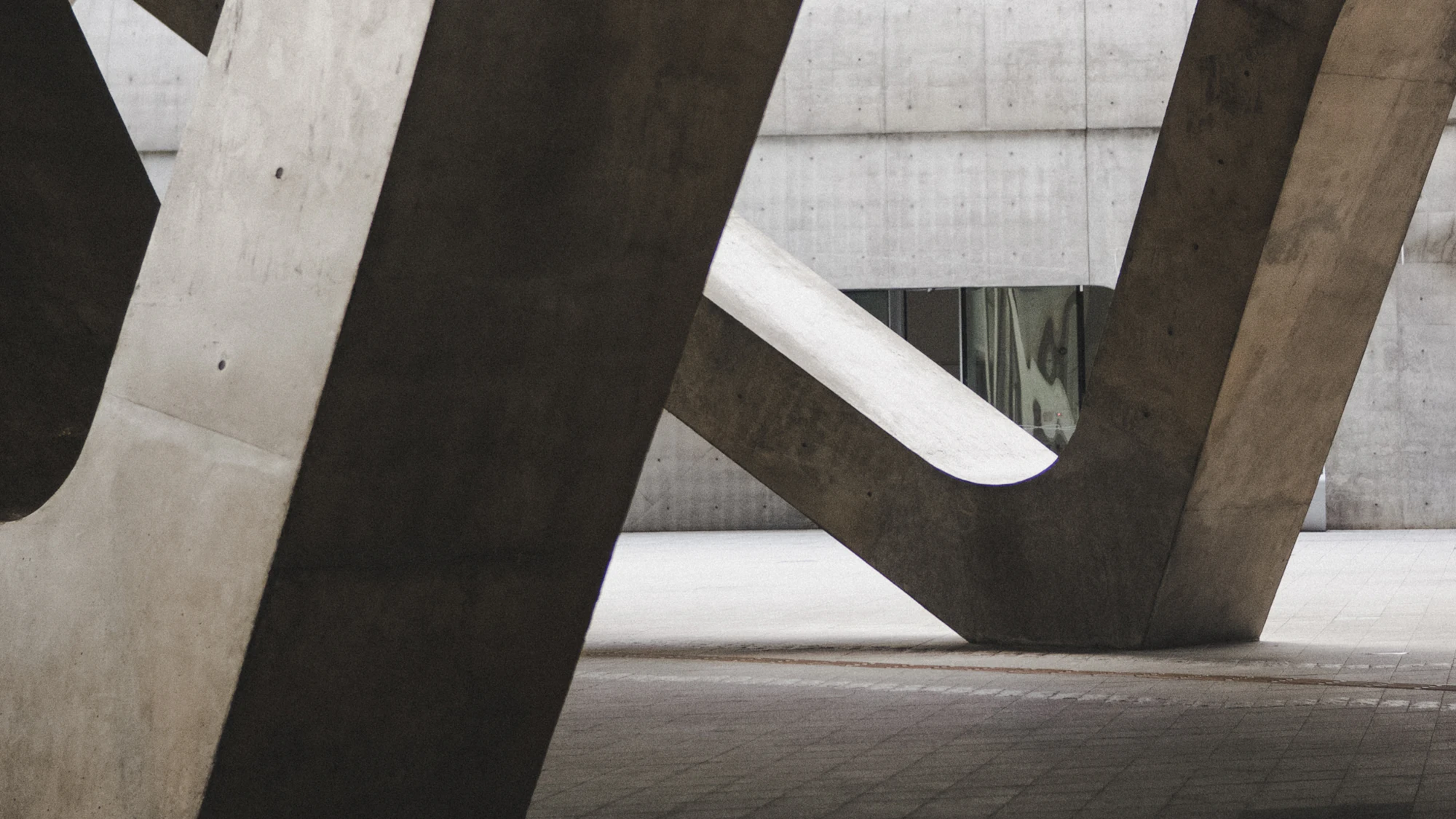 Cast concrete structural frame meeting a shaded soffit