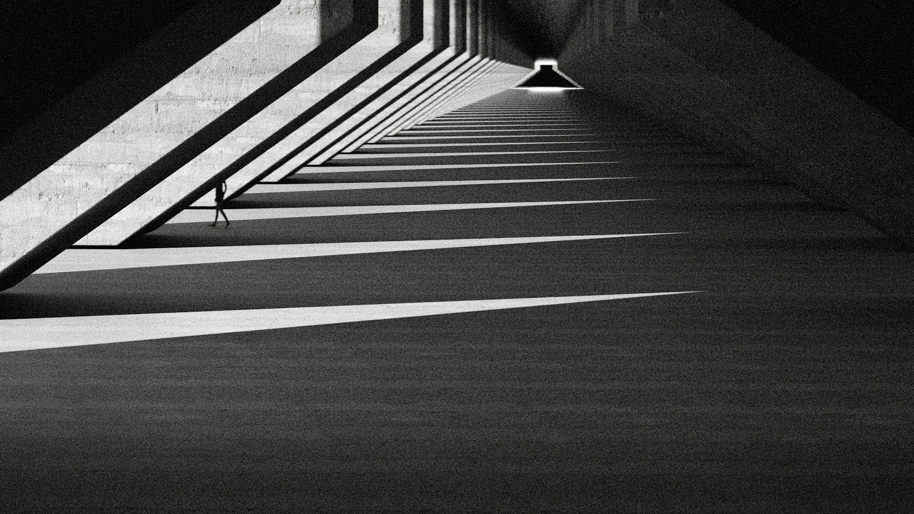 Long concrete colonnade receding into raking light
