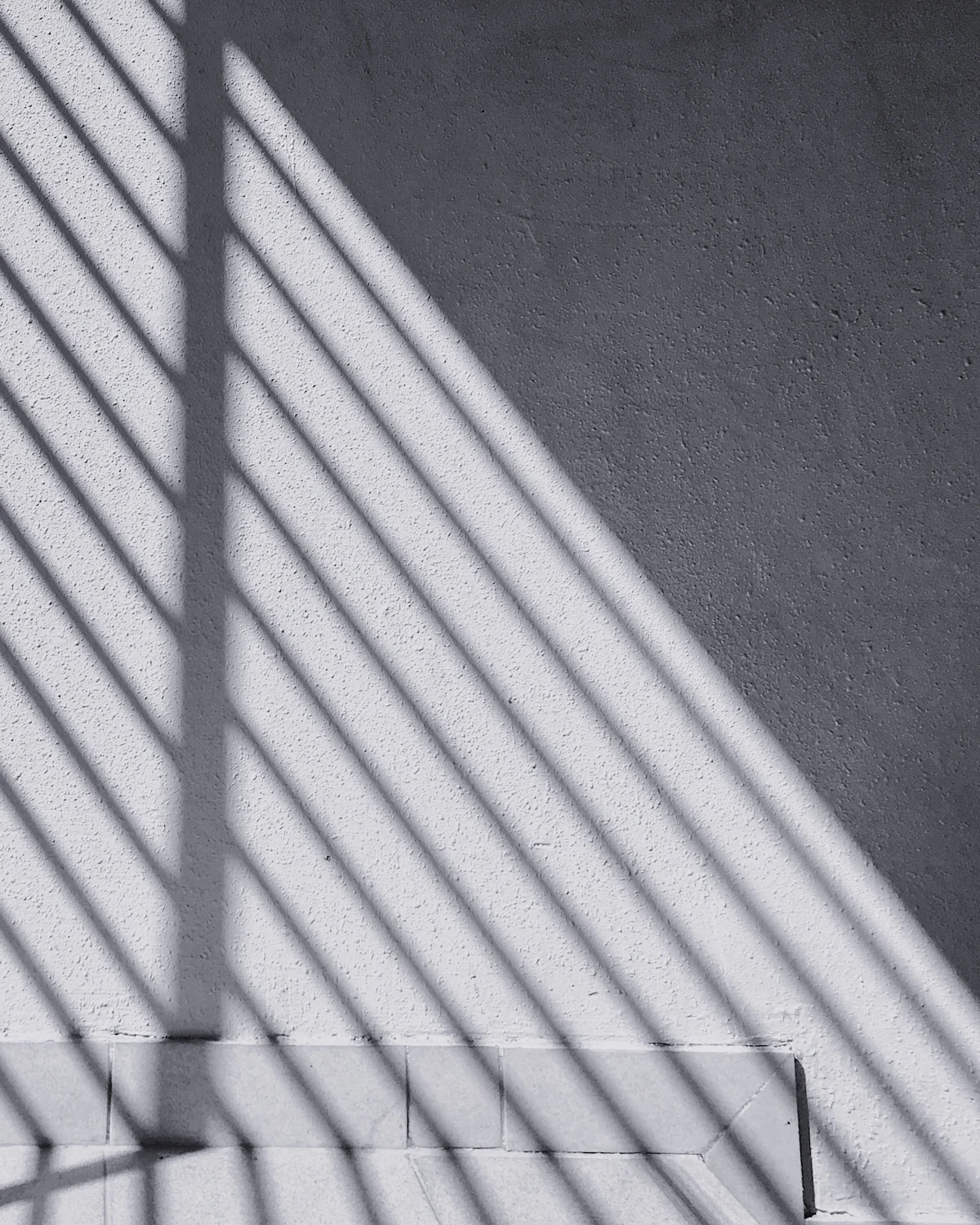 Linear shadow bands across a fine concrete plane